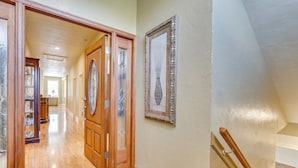 A hallway with wooden flooring, a wooden door, and a framed picture on the wall. - Explore Historic Dtwn! Walkable Loft in Murphy (Murphy)