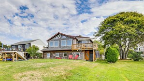 A two-story house with a deck, a covered porch, and a fenced yard. - Dock + Water Access: Charlestown Beach Escape! (Charlestown)