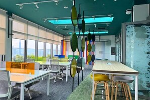 An office space with cubicles, a long table, and chairs. - The Riv - Riveria City KL Sentral by Sleepy Bear (Kuala Lumpur)
