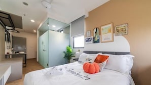 A modern bedroom with a bed, a desk, and a glass partition. - The Riv - Riveria City KL Sentral by Sleepy Bear (Kuala Lumpur)
