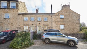 A stone building with a car parked in front. - Host & Stay | Dairy Cottages (Masham)