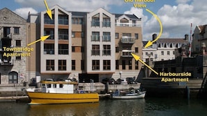 A waterfront building with labeled sections including Townbridge Penthouse, Old Harbour View, and Harbourside Apartment. - Harbourside Apartment (Weymouth)