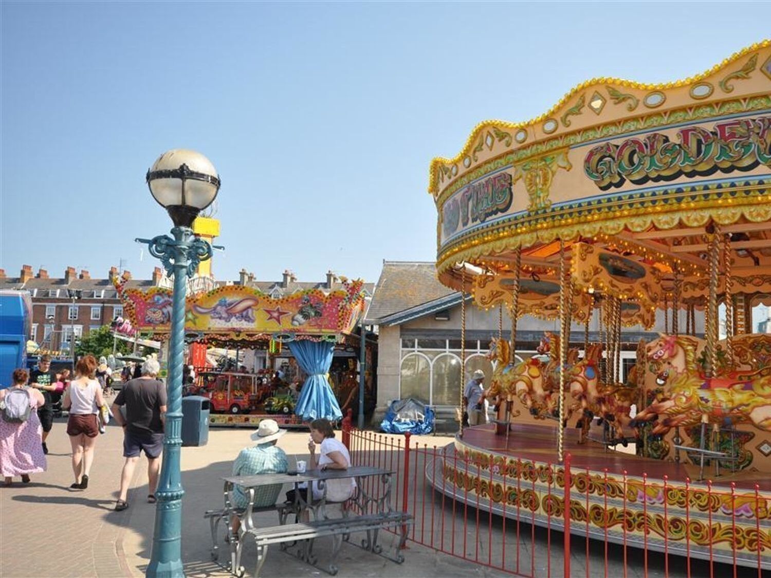 A carousel with colorful horses and a decorative canopy.