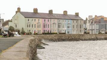 A row of colorful terraced houses by the sea.