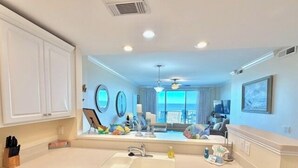 A modern kitchen with white cabinets, a double sink, and a dishwasher. - Summer & July 4th Savings at Beachside Colony Tybee's ONLY Oceanfront Resort 2/2 (Tybee Island)
