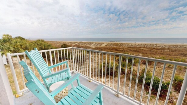 A balcony with turquoise chairs overlooking a beach. - Summer & July 4th Savings at Beachside Colony Tybee's ONLY Oceanfront Resort 2/2 (Tybee Island)