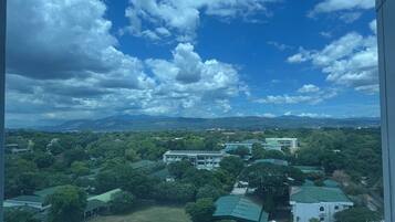A view of a campus with multiple buildings, green spaces, and a parking area.