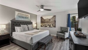 A modern bedroom with a large bed, a desk, and a chair. - Grand Camino: Stylish Vibes, Pool, Grille, Firepit (Scottsdale)
