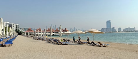 Private beach, white sand, sun loungers, beach umbrellas