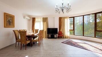 Deluxe Apartment, Balcony, Park View | Living area | 50-inch flat-screen TV with cable channels