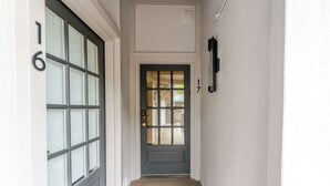 A hallway with a dark gray door, a light-colored wall, and a number '16' on the left. - Aspen Downtown 2BR Ski Condo w/ Fireplace - CD 17 (Aspen)