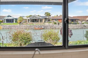 A residential area with a lake, houses, and a boat dock. - 17 Matthew Flinders Dve Encounter Bay (Encounter Bay)
