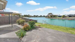 A residential area with a swimming pool, a covered patio, and a view of a lake. - 17 Matthew Flinders Dve Encounter Bay (Encounter Bay)