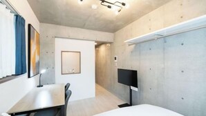 A modern hotel room with a bed, desk, chair, TV, and a large window with curtains. - Ferio Kamata II (Tokyo)