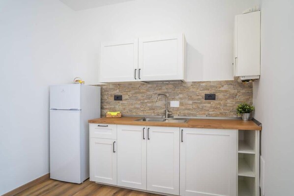 Fridge, microwave, cookware/dishes/utensils, dining tables
