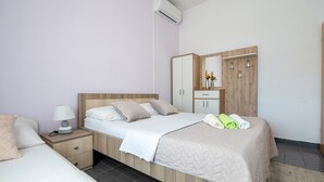 Ein Schlafzimmer mit Bett, Nachttisch, Kommode und Spiegel.
