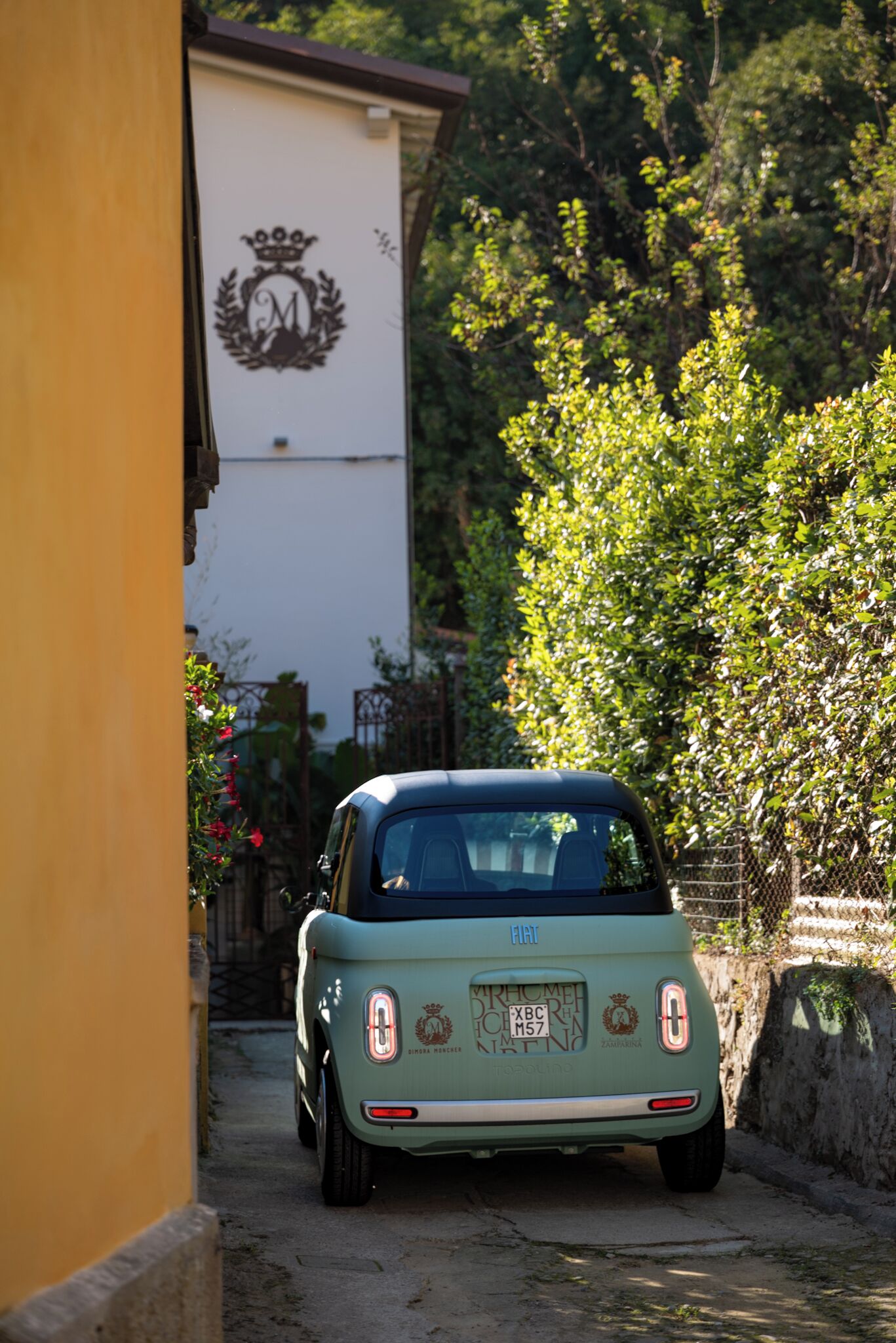 Une vieille voiture Fiat garée dans une rue étroite.