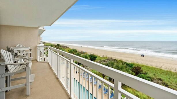 A balcony with a view of a beach and ocean. - Crescent Shores 309- Oceanfront 2 BBR- Pool (North Myrtle Beach)