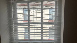 A window with horizontal blinds, a small plant, and three candles on the sill. - The Courtyard View Sligo! (Sligo)