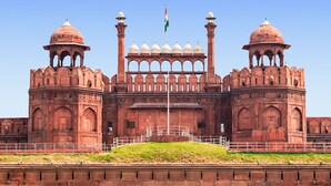 A large, historic building with two prominent domes, a central archway, and a flagpole with a flag. - Hotel Kelson Dx  (New Delhi)