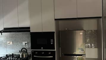 Luxury Apartment, Pool View | Private kitchen | Full-sized fridge, microwave, oven, cookware/dishes/utensils