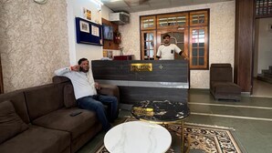 A reception area with a reception desk, a clock on the wall, a sofa, and a patterned rug. - Staylo Masterprice Inn (Lucknow)