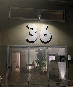 A building entrance with the number 36 prominently displayed above the door. - LoftDesign (Verona)