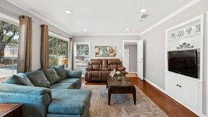 A spacious living room with a sectional sofa, a recliner, and a coffee table. - Wonder World Retreat (San Marcos)