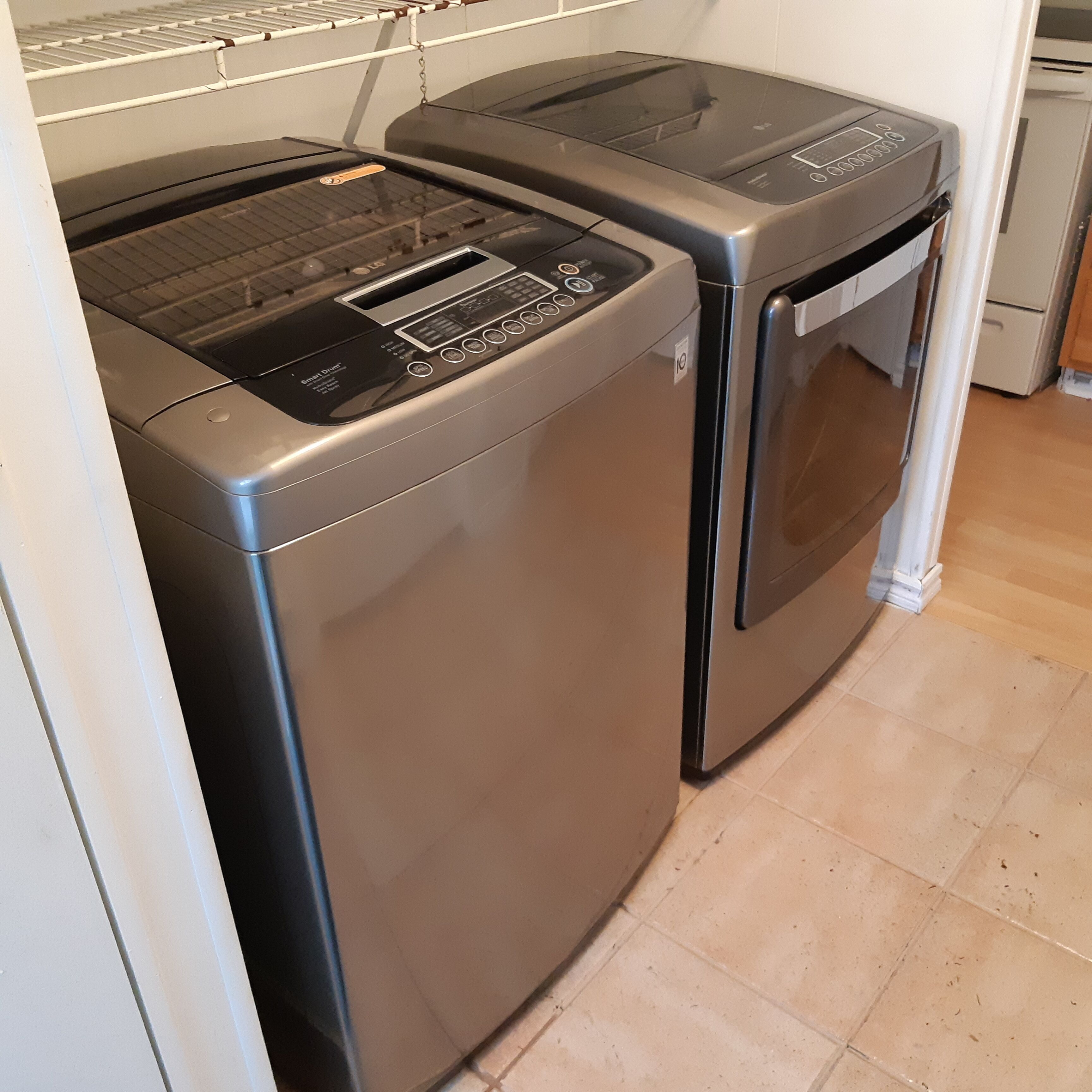 A compact, modern laundry room with a front-loading washer and dryer.