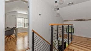 A staircase with wooden steps and metal railings, leading to an upper floor.