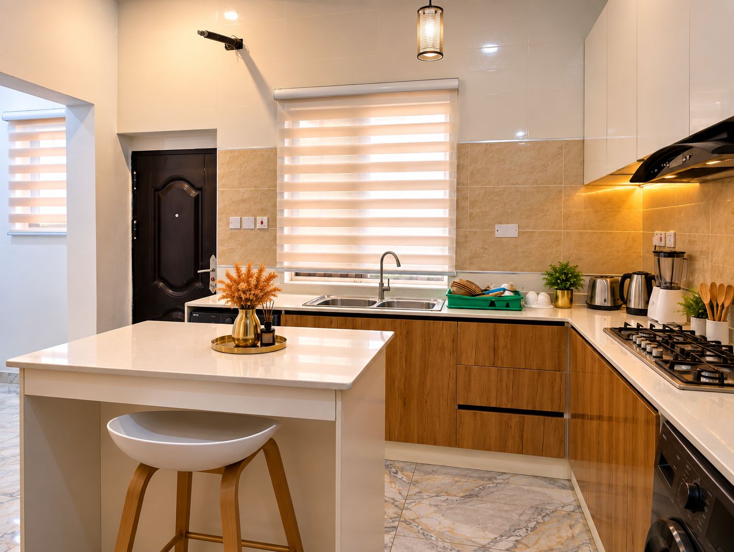 A modern kitchen with a central island, a built-in oven, and a gas stove.