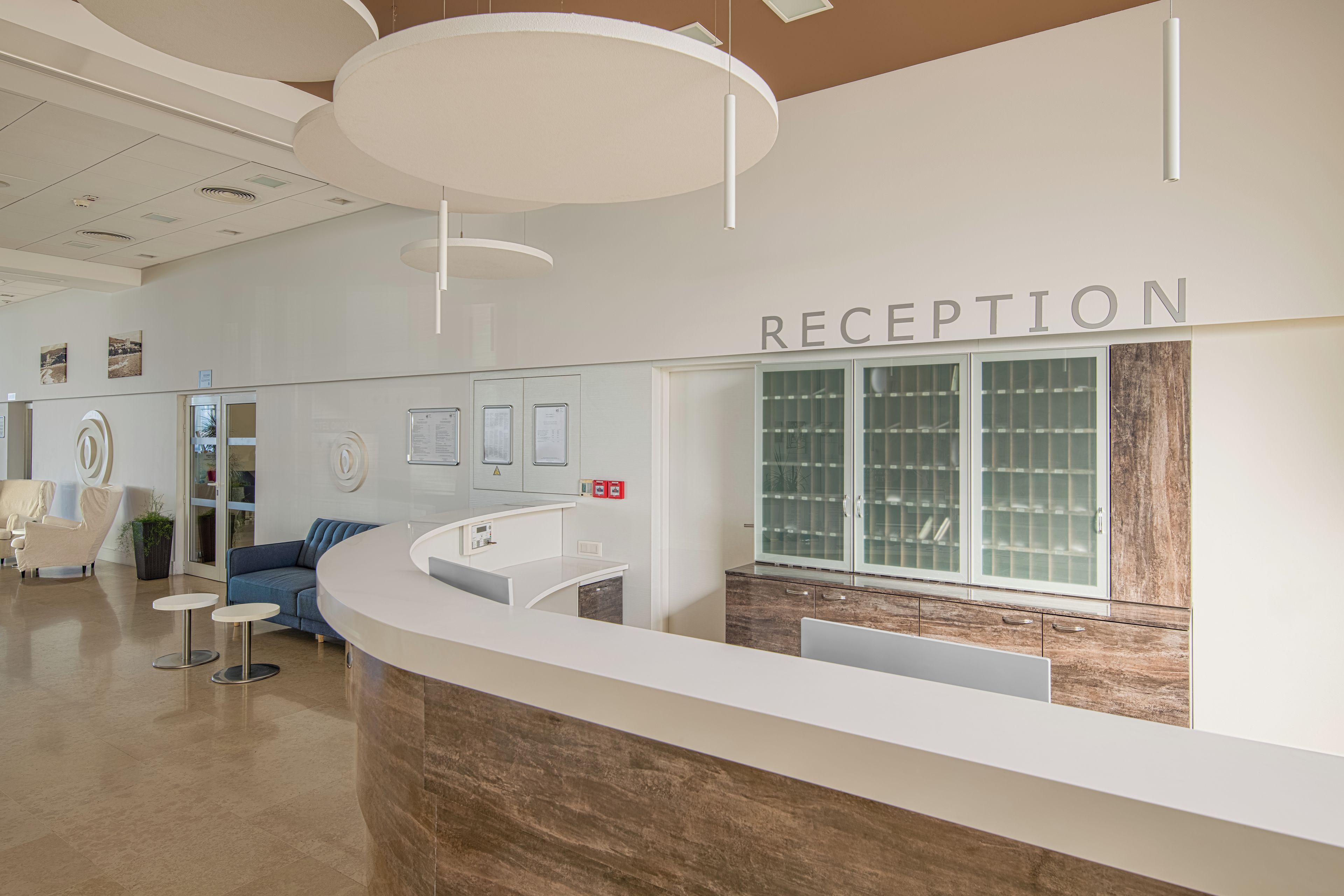 A reception area with a counter, seating, and a reception desk.
