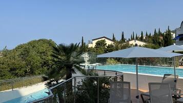 Seasonal outdoor pool, open 10:00 AM to 7:00 PM, pool umbrellas