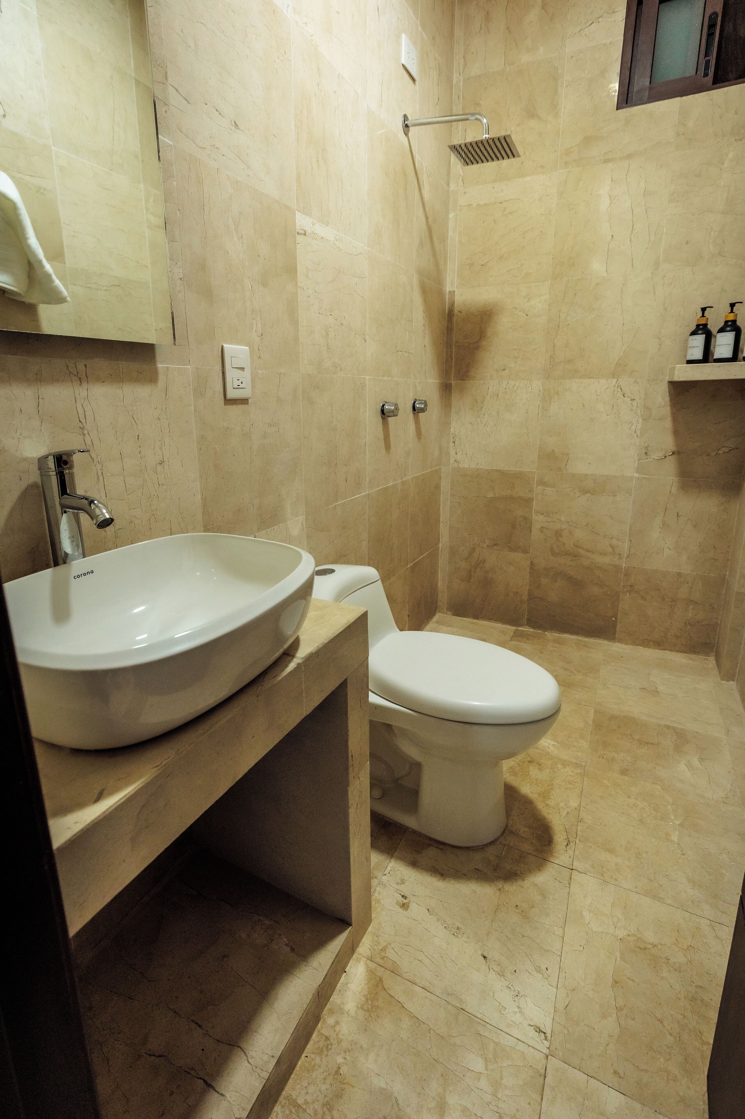 A bathroom with a sink, toilet, and shower.