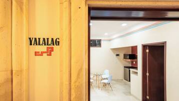 A reception area with a wooden pillar displaying the name 'YALALAG'.