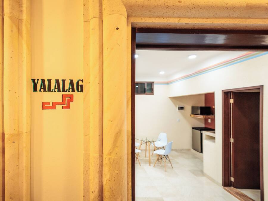 A reception area with a wooden pillar displaying the name 'YALALAG'.