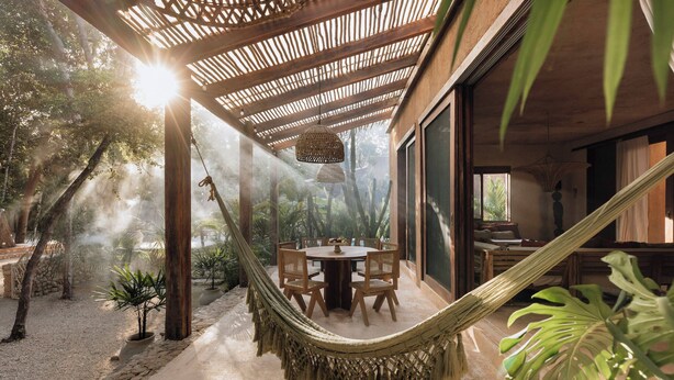 A hammock under a wooden pergola, a round table with chairs, and a view of tropical vegetation. - Villa Najil Chak Tulum : 16 Guests : Private Pool : Groups Retreats & Events (Tulum)