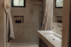 A bathroom with a large mirror, a sink, and a shower. - Villa Najil Chak Tulum : 16 Guests : Private Pool : Groups Retreats & Events (Tulum)