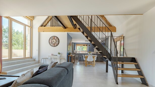A modern interior with a staircase, a dining area, and a living space. - Les Huttes (Montgesty)