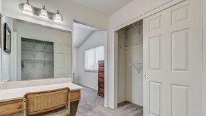 A bathroom with a vanity, mirror, and shower area. - Spacious 4 bedroom with 7 beds! (Las Vegas)