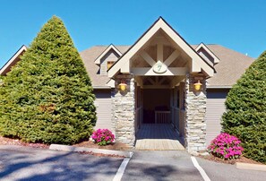 A lodge with a stone facade, a pitched roof, and a number '7' sign.