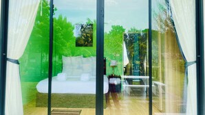 A bedroom with a large sliding glass door leading to a balcony. - Leelavadee Villa Sea Views (Tha Sala)