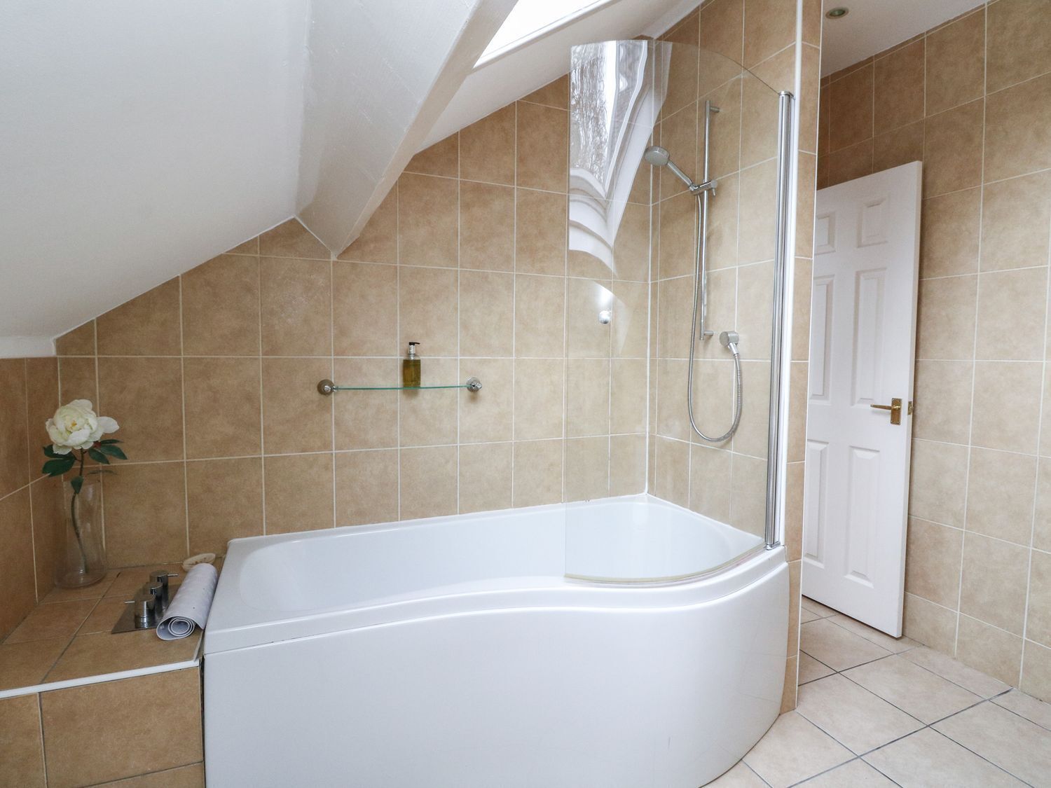 A modern bathroom with a freestanding bathtub, a shower, and a toilet.
