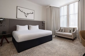 A hotel room with a large bed, a sofa, a desk, and a large window with curtains. - Bruntsfield Hotel, WorldHotels Elite (Edinburgh)