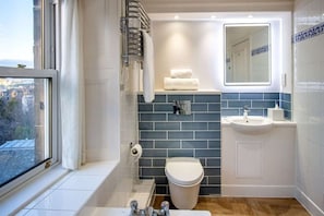 A bathroom with a bathtub, toilet, sink, and a window. - Bruntsfield Hotel, WorldHotels Elite (Edinburgh)