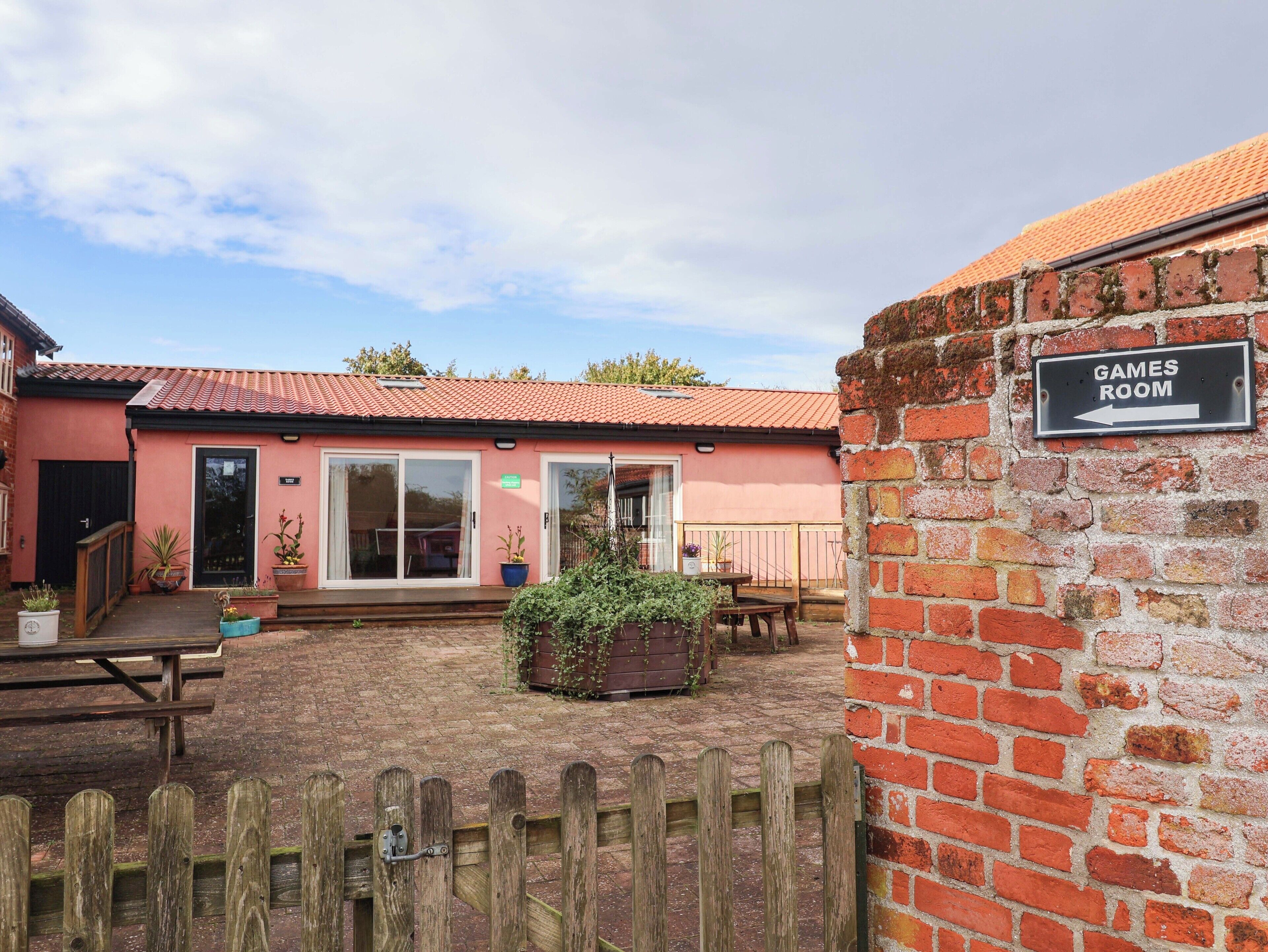 A pink building with a sign indicating a games room.