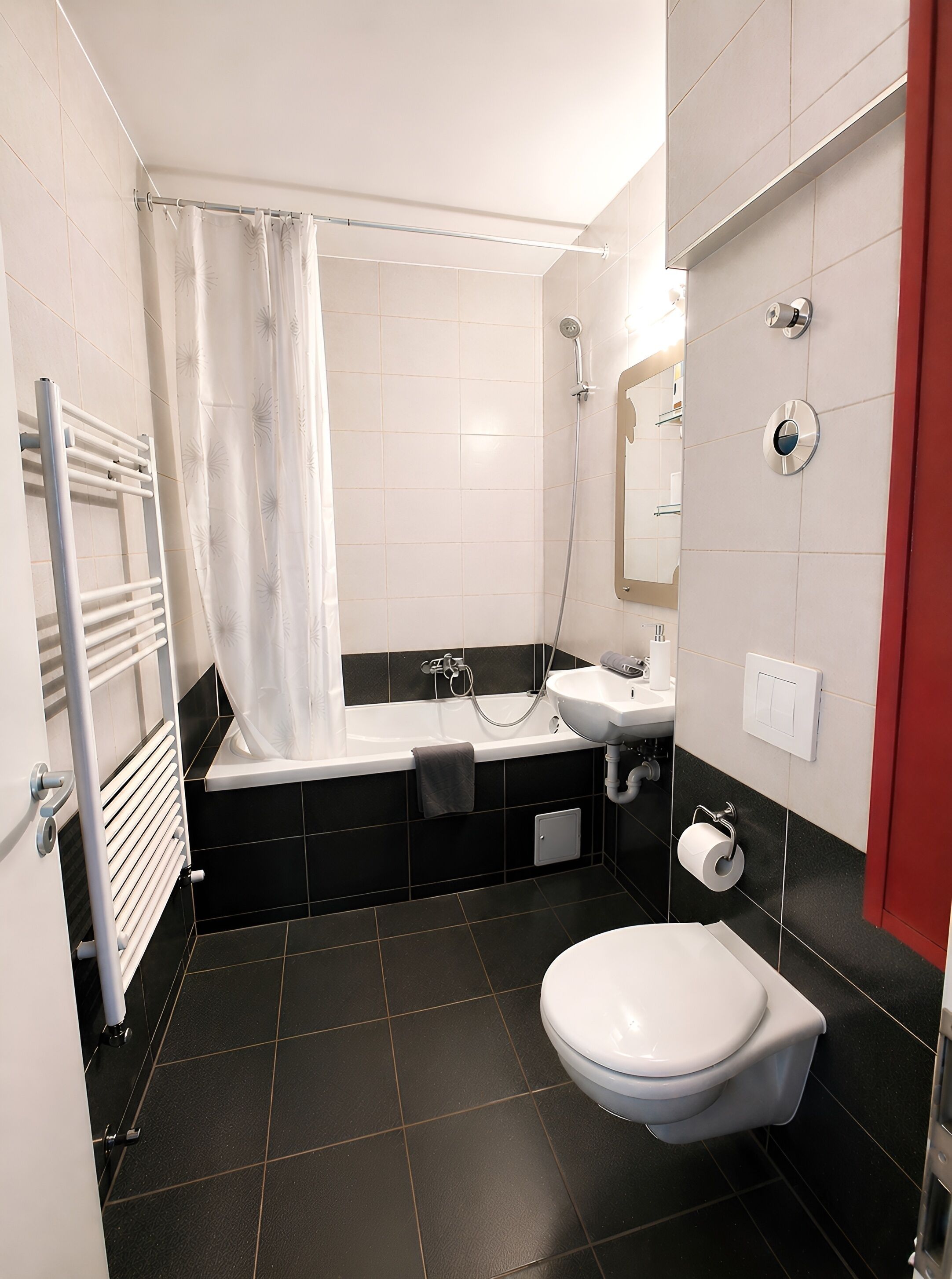 A modern bathroom with a bathtub, toilet, sink, and shower.