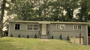 A single-story house with a front porch, a small front yard, and a wooden gate. - Home Away From Home!!! (Birmingham)