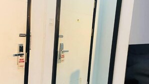 A hotel room with a closed door, a visible handle, and a 'Do Not Disturb' sign. - Yama Hotel & Rooftop Bar (Botataung)