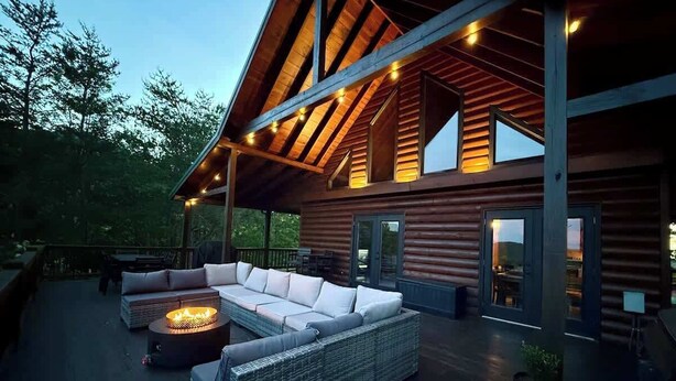 A modern log cabin with a covered outdoor seating area featuring a large sectional sofa and a fire pit. - NEW-Mountian Views! Hot Tub-Game Room-Near Town (Blue Ridge)
